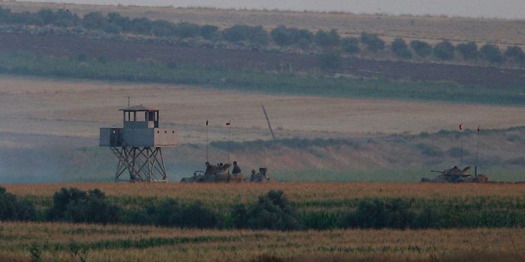 Turkish army tanks hold positions next to an outpost, near the border with Syria, in the outskirts of the village of Elbeyi, east of the town of Kilis, in southeastern Turkey, Thursday, July 23, 2015. Suspected Islamic State militants fired at a Turkish military outpost from a region under IS control, inside Syrian territory Thursday, killing a Turkish soldier and wounding two others, an official said. Turkish troops retaliated to the attack and at least one IS militant was killed, amid a surge of violence in Turkey following a suicide bomb attack near Turkey's border with Syria which killed 32 people. (AP Photo/Emrah Gurel),