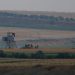 Turkish army tanks hold positions next to an outpost, near the border with Syria, in the outskirts of the village of Elbeyi, east of the town of Kilis, in southeastern Turkey, Thursday, July 23, 2015. Suspected Islamic State militants fired at a Turkish military outpost from a region under IS control, inside Syrian territory Thursday, killing a Turkish soldier and wounding two others, an official said. Turkish troops retaliated to the attack and at least one IS militant was killed, amid a surge of violence in Turkey following a suicide bomb attack near Turkey's border with Syria which killed 32 people. (AP Photo/Emrah Gurel),