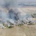 In this image taken from drone video provided by Free Burma Rangers, black smoke arises from burning buildings in Waraisuplia village in Kayah State, Myanmar on Feb. 18, 2022. While Russia’s war in Ukraine dominates global attention, Myanmar’s military is targeting civilians in air and ground attacks on a scale unmatched in the country since World War II, according to a longtime relief worker who spent almost three months in a combat zone in the Southeast Asian nation. (Free Burma Rangers via AP)
