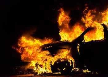 Car in fire, burning at night